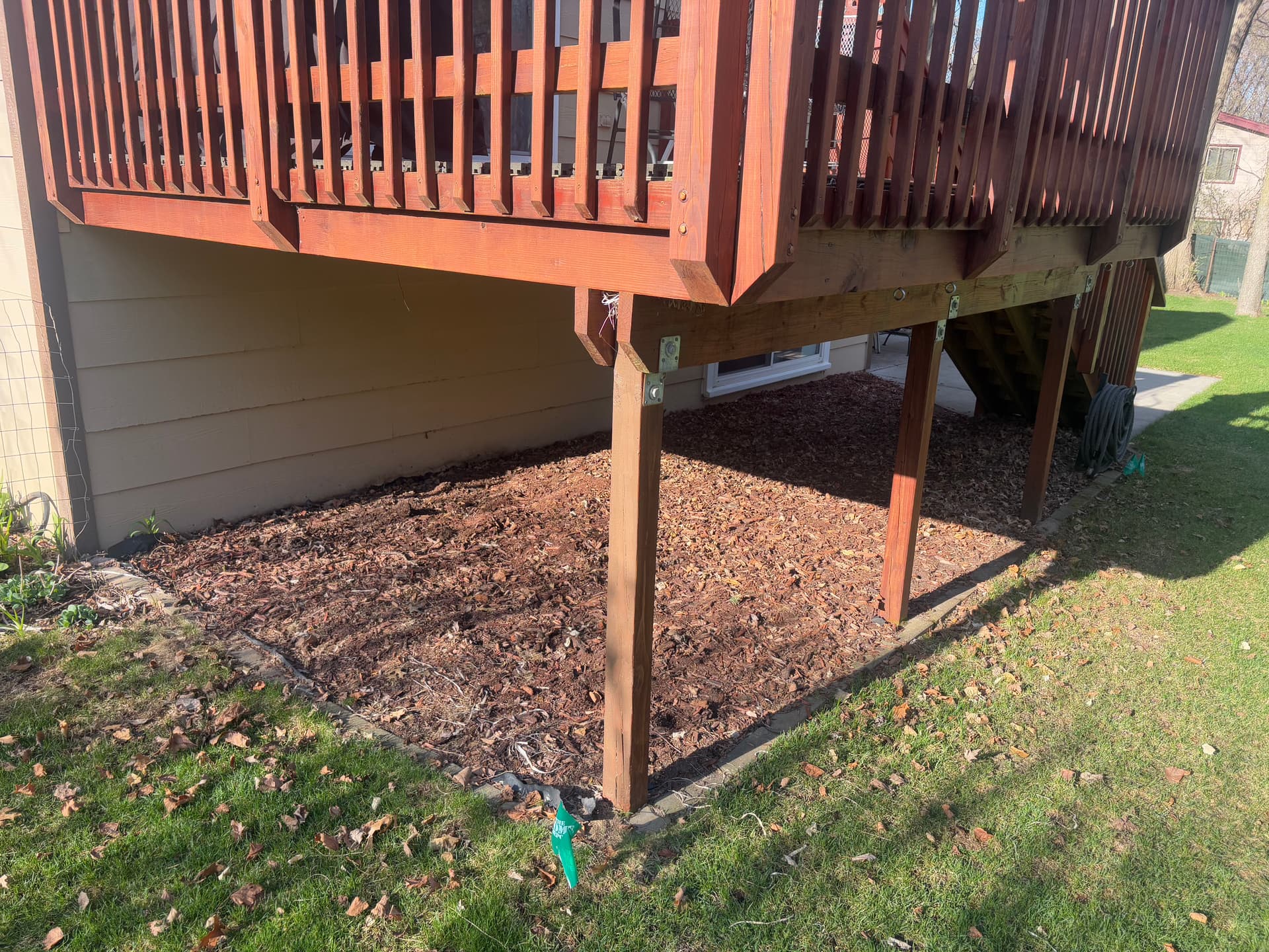 Old Mulch Swapped for a Clean Rock Bed Under This Deck image