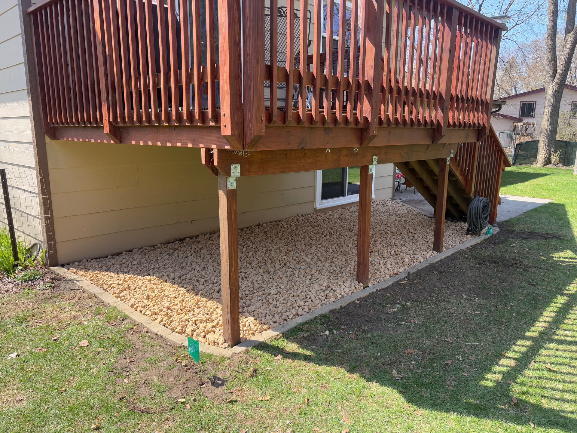 Gallery photos for Old Mulch Swapped for a Clean Rock Bed Under This Deck: Image #1