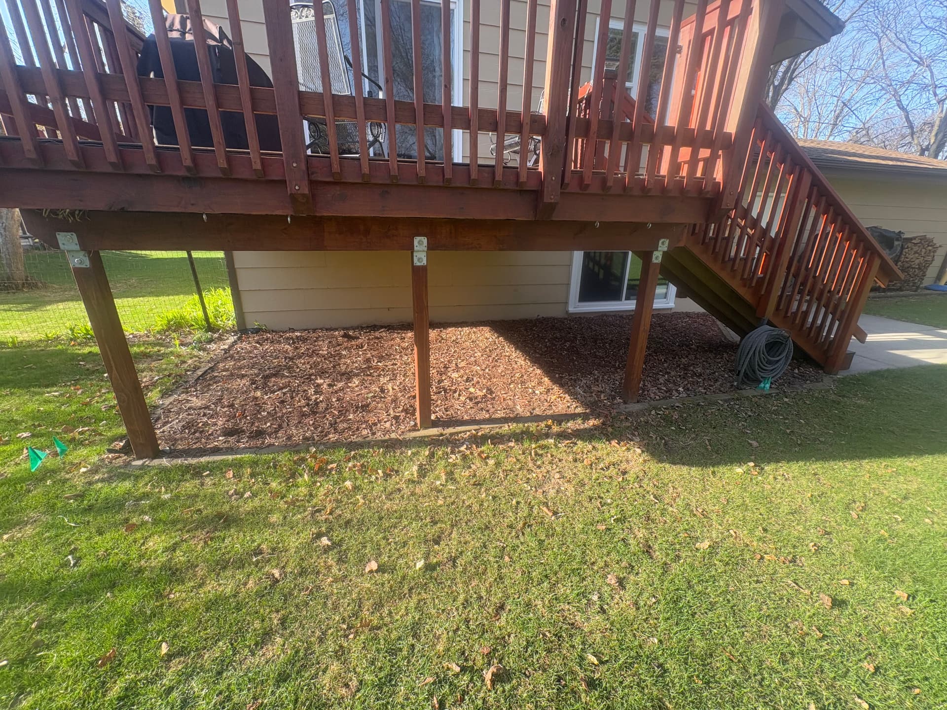 Gallery photos for Old Mulch Swapped for a Clean Rock Bed Under This Deck: Image #2